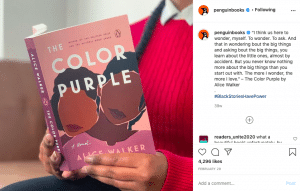 A woman reading The Color Purple, a novel.