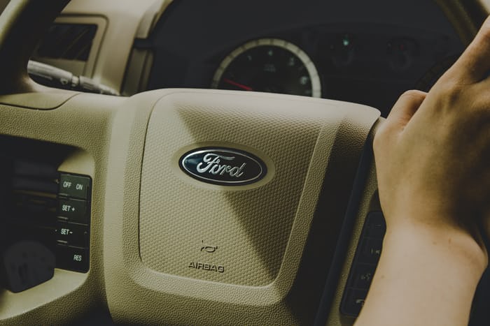 automobile copywriting example: Ford steering wheel shown with hand on it