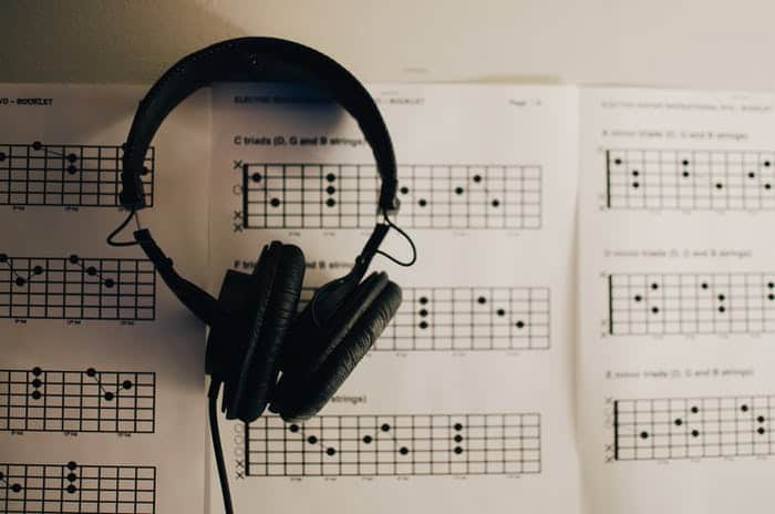 headphones over guitar chords on music sheet