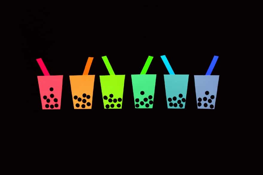 A graphic art of 6 cups of bubble tea drinks in colors of the rainbow